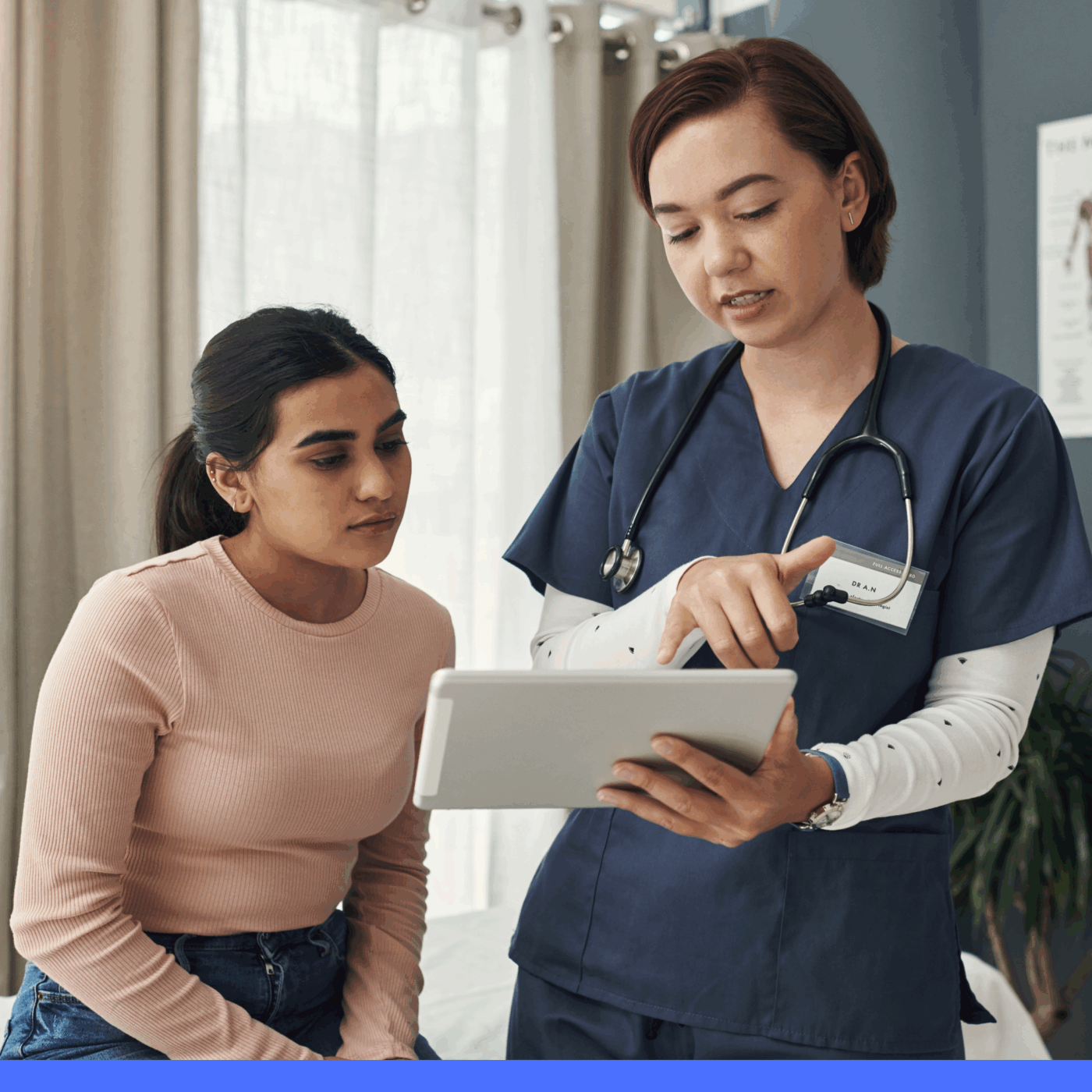 Doctor and patient. Doctor pointing to a tablet.